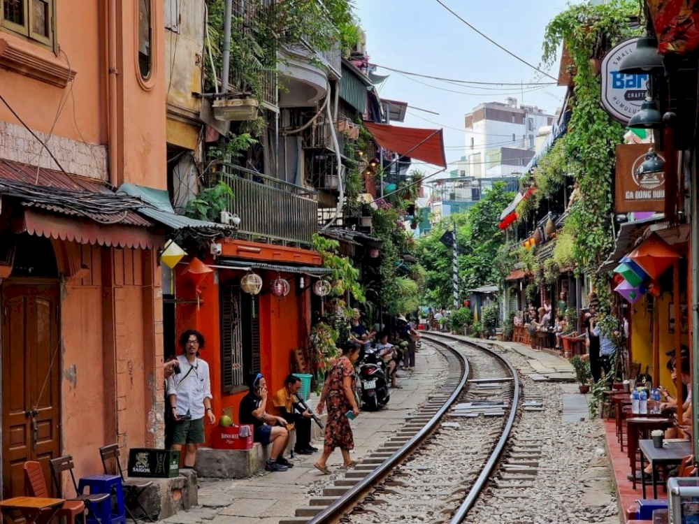 The narrow street is just wide enough for the train to pass through